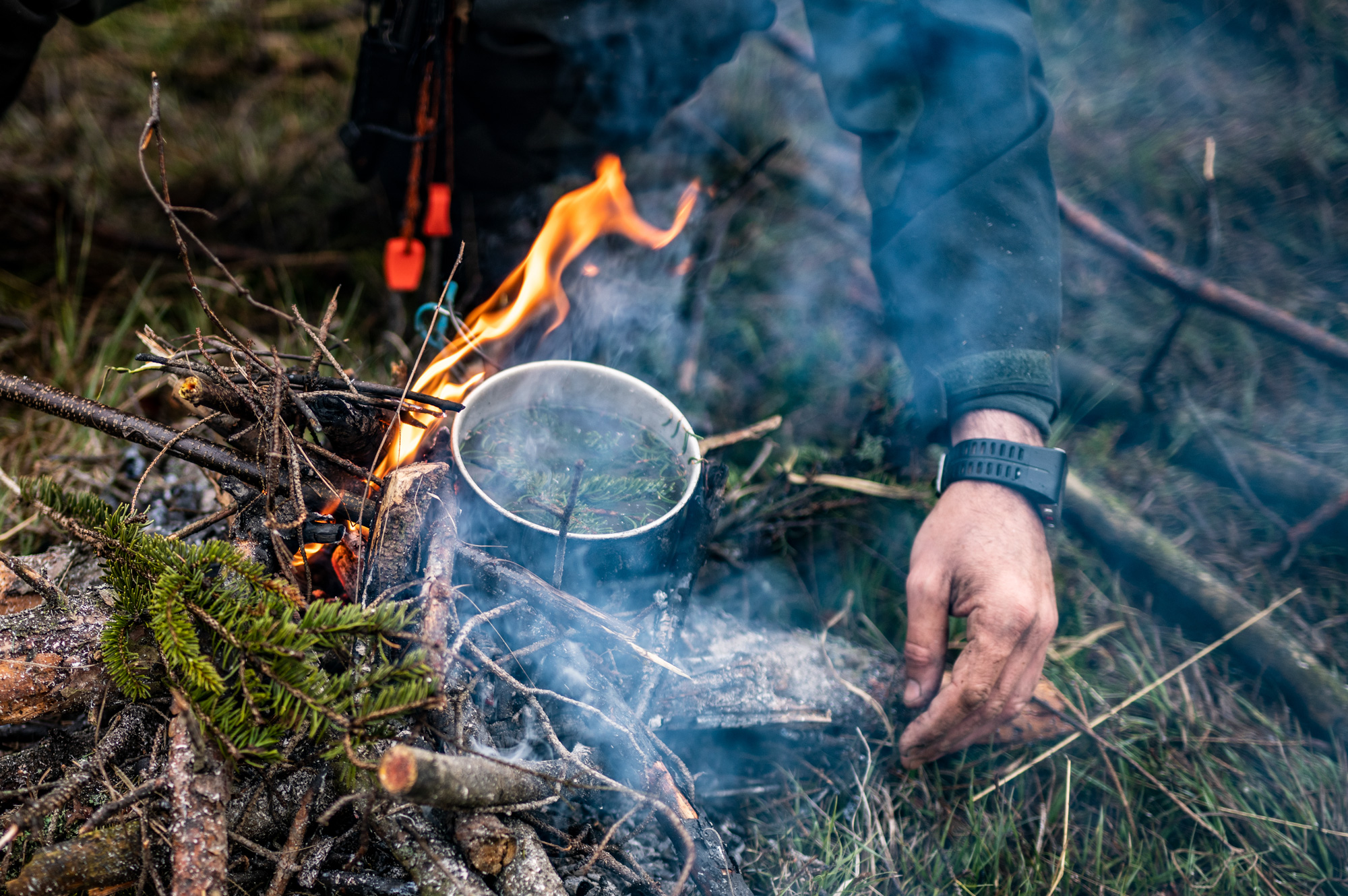 cooking in a pot over a campfire