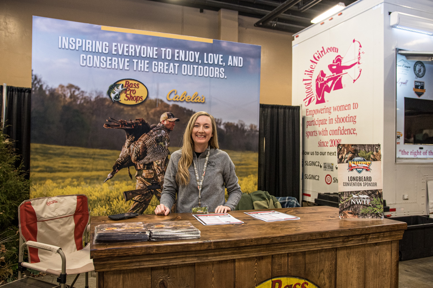 woman at a booth during nwtf convention promoting the bass pro shops outdoor fund
