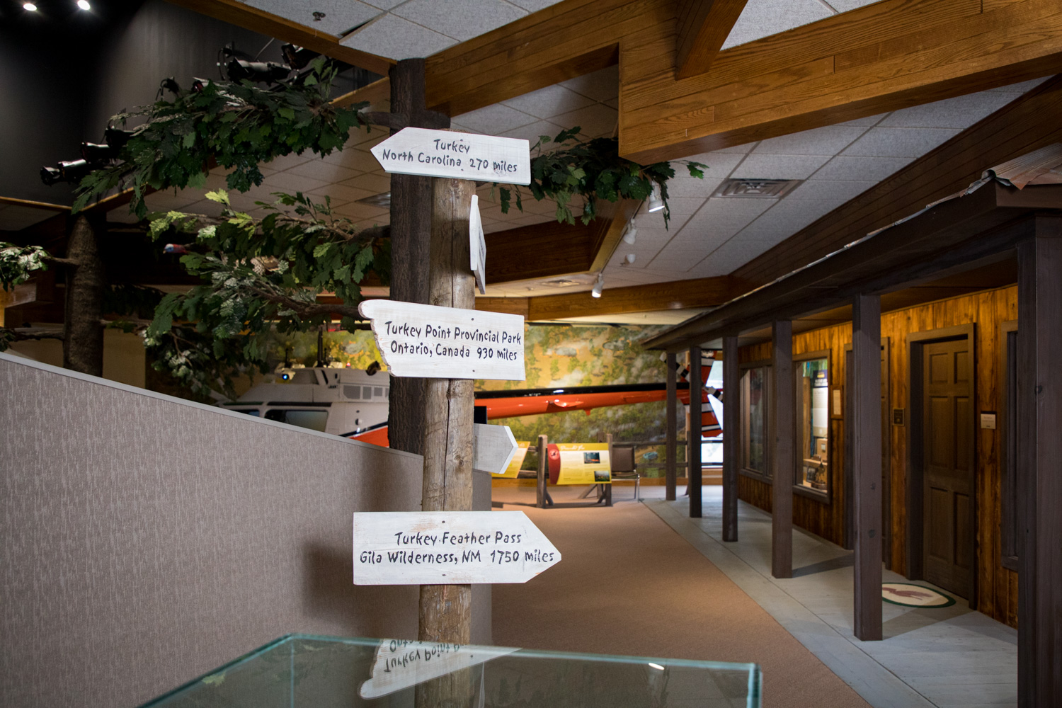 sign in the winchester museum at nwtf headquarters poinds to numerous turkey related landmarks across the country