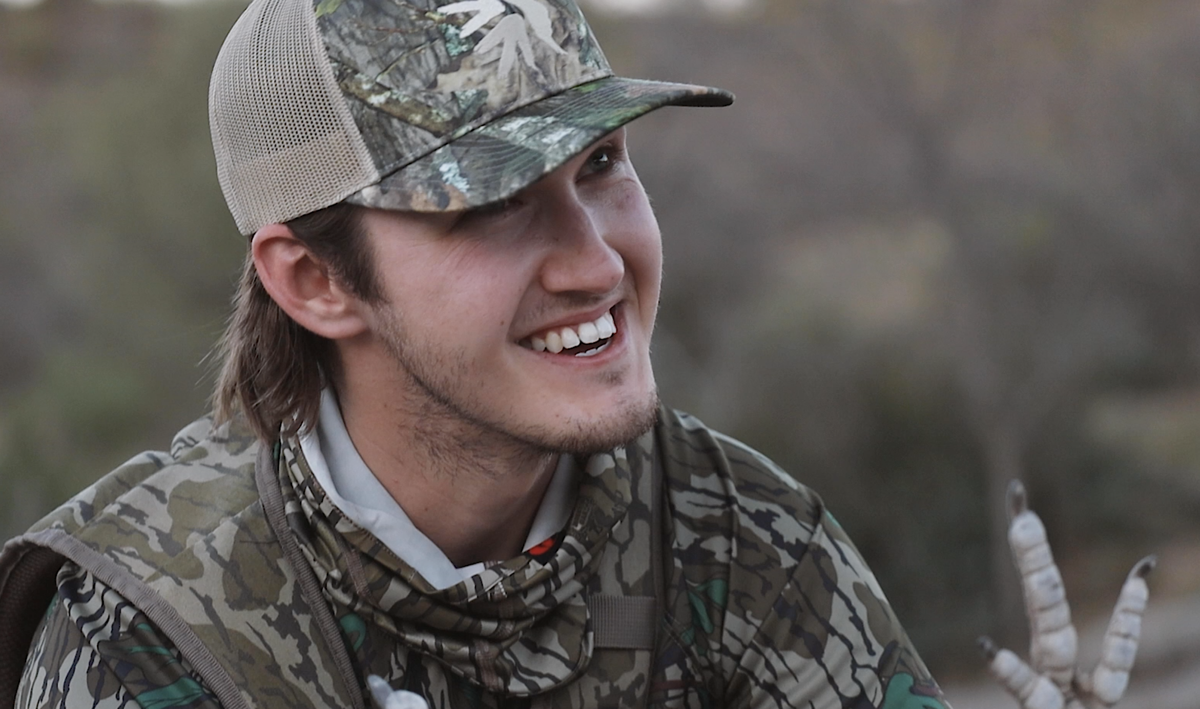 man in camo smiling