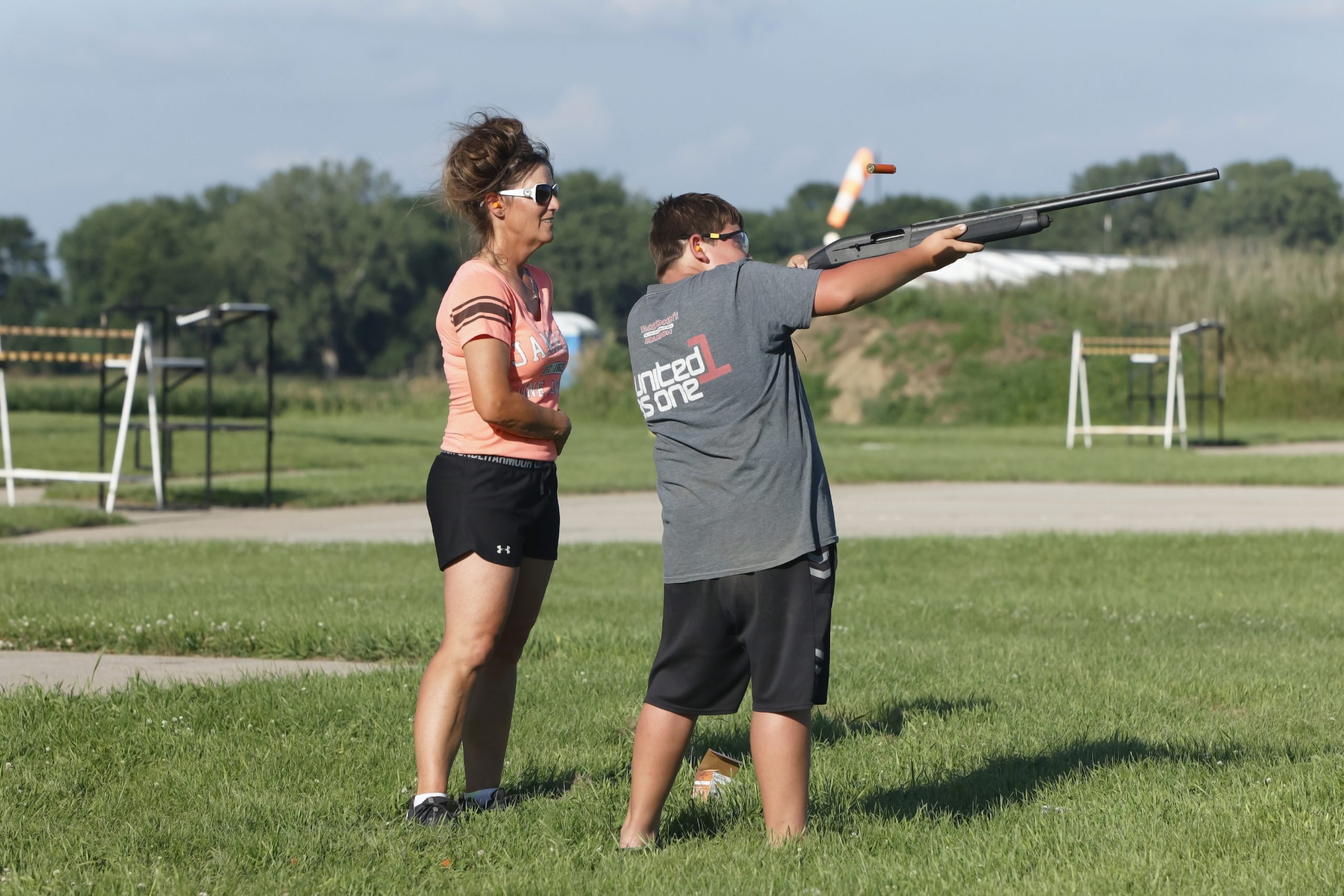 A young participant in the Brandon Boss Gobblers Jakes event shoots at a clay pigeon as one of the volunteer instructors looks on.
